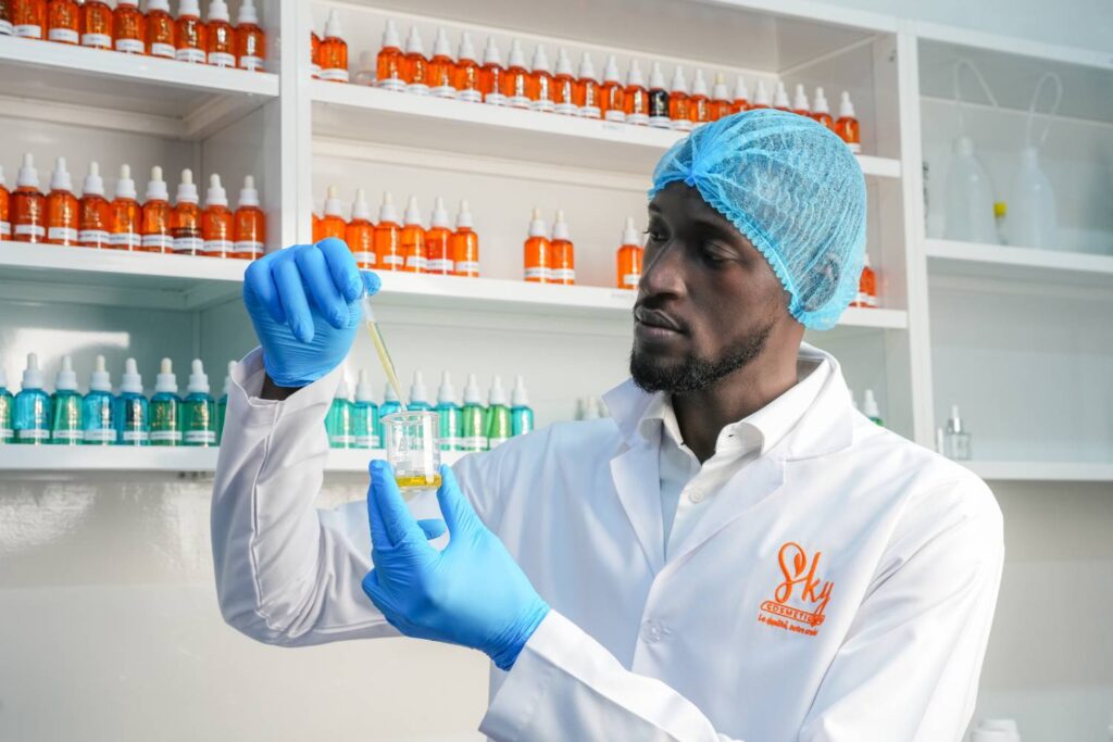 Perfume chemist analyzing fragrance oil formulation in SkyCosmetics fragrance manufacturing laboratory